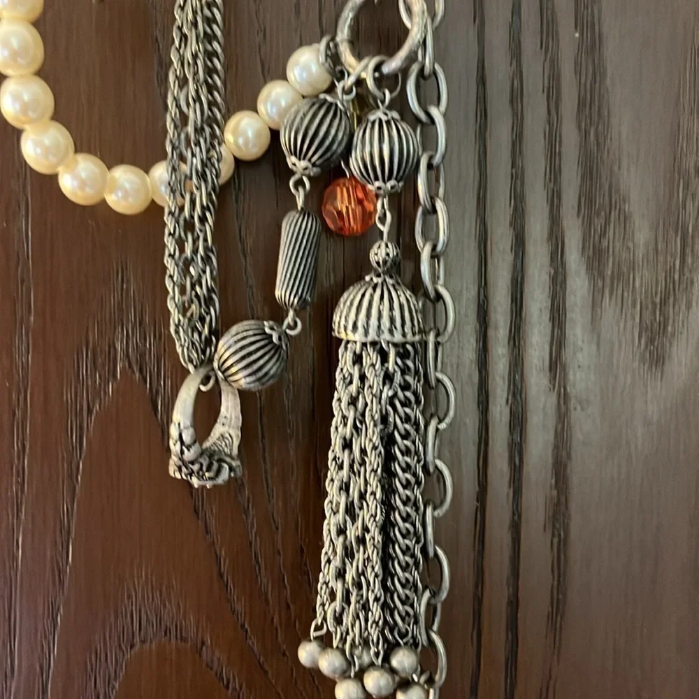 Women’s double chain belt. One of metal objects and the second chain of pearls.